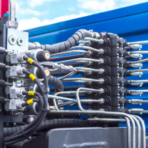 Close up of pipe system of hydraulic valves in agricultural machinery